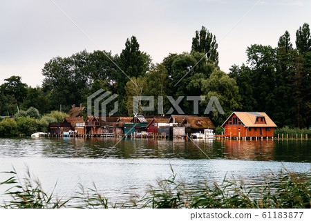 Old wooden cottages on the lake shore in Schwerin, Germany Old wooden cottages on the lake shore in Schwerin, Germany 61183877