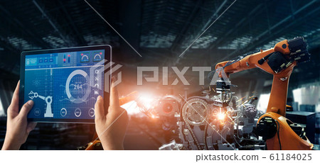 Engineer check and control welding robotics automatic arms machine in intelligent factory automotive industrial with monitoring system software. Digital manufacturing operation. Industry 4.0 Engineer check and control welding robotics automatic arms machine in intelligent factory automotive industrial with monitoring system software. Digital manufacturing operation. Industry 4.0 61184025