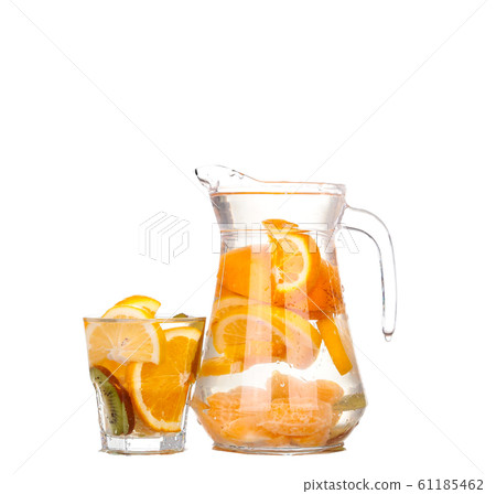 pitcher with a refreshing drink with lemon slices pitcher with a refreshing drink with lemon slices 61185462