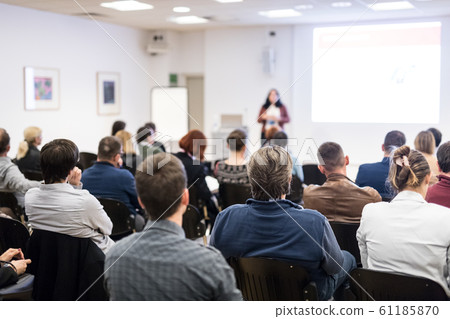 Woman giving presentation on business conference workshop. Woman giving presentation on business conference workshop. 61185870