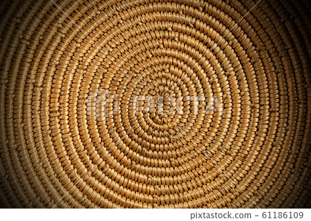 Background of a spiral woven wicker texture - Detail of a basket 61186109