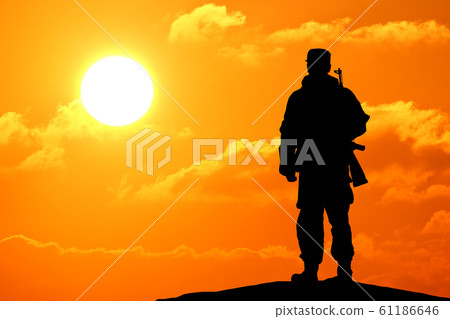 Silhouette shot of soldier holding gun with Silhouette shot of soldier holding gun with 61186646