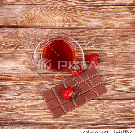A cup of tea or coffee. Dark Chocolate. Wooden A cup of tea or coffee. Dark Chocolate. Wooden 61186960