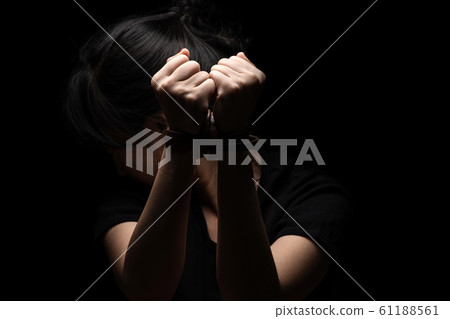 Woman tied up with leather belt in emotional Woman tied up with leather belt in emotional 61188561