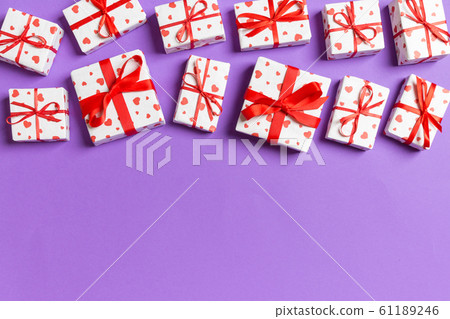 Top view of gift boxes with red hearts on colorful Top view of gift boxes with red hearts on colorful 61189246