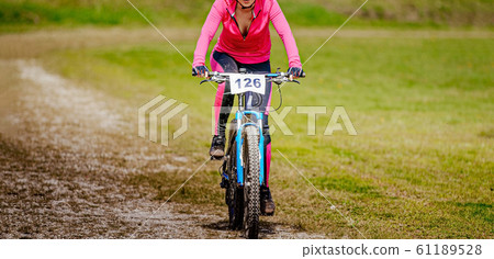 female cyclist riding trail on mountain bike female cyclist riding trail on mountain bike 61189528