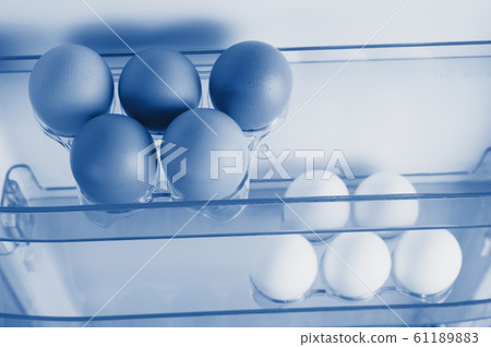 Open fridge, eggs on the shelf of refrigerator Open fridge, eggs on the shelf of refrigerator 61189883