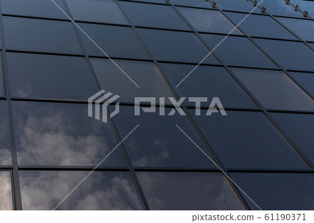 close-up picture mirror reflection of clouds in a glass mirror window of a skyscraper 61190371