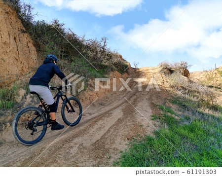 MTB biker on a sandy road 61191303