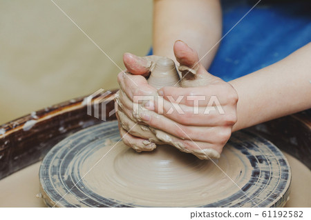Woman hands on pottery wheel. Craftsman artist Woman hands on pottery wheel. Craftsman artist 61192582