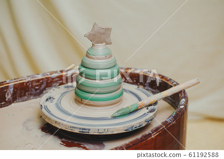 Painted pot with christmas tree form on pottery Painted pot with christmas tree form on pottery 61192588