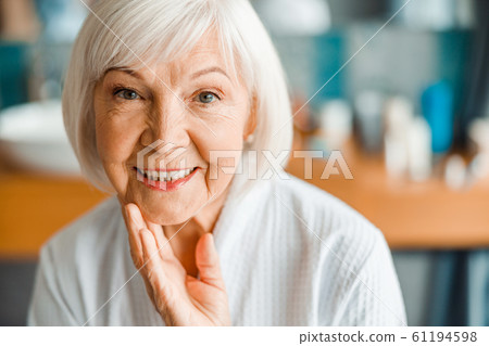 Lovely old woman looking at camera and smiling 61194598