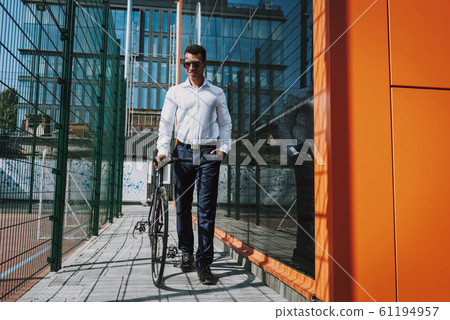 Merry man walking with bike stock photo Merry man walking with bike stock photo 61194957