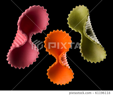 Set of colourful farfalle pasta isolated on black background 61196118