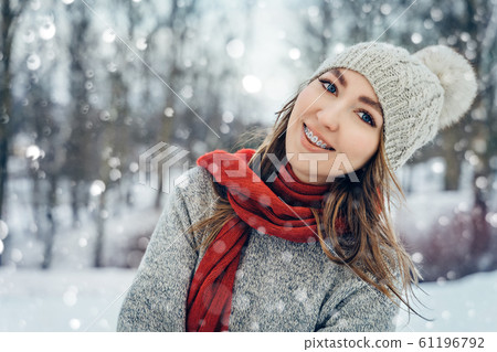 Winter young woman portrait. Beauty Joyful Model Girl laughing and having fun in winter park. Beautiful young female outdoors, Enjoying nature, wintertime Winter young woman portrait. Beauty Joyful Model Girl laughing and having fun in winter park. Beautiful young female outdoors, Enjoying nature, wintertime 61196792