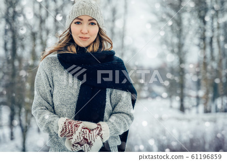 Winter young woman portrait. Beauty Joyful Model Girl laughing and having fun in winter park. Beautiful young female outdoors, Enjoying nature, wintertime Winter young woman portrait. Beauty Joyful Model Girl laughing and having fun in winter park. Beautiful young female outdoors, Enjoying nature, wintertime 61196859