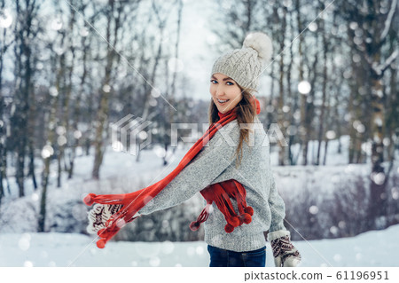 Winter young woman portrait. Beauty Joyful Model Girl laughing and having fun in winter park. Beautiful young female outdoors, Enjoying nature, wintertime Winter young woman portrait. Beauty Joyful Model Girl laughing and having fun in winter park. Beautiful young female outdoors, Enjoying nature, wintertime 61196951