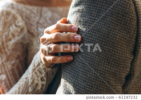 Closeup of a woman hugging a man. Closeup of a woman hugging a man. 61197232