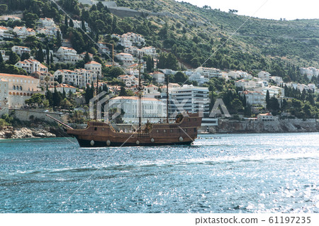 Ship on the background of buildings Ship on the background of buildings 61197235