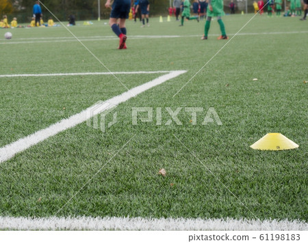 Close-up of soccer turf within kids training. Close-up of soccer turf within kids training. 61198183
