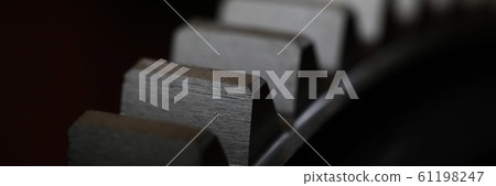 Closeup of metal cogwheel on dark background as part of full machine 61198247