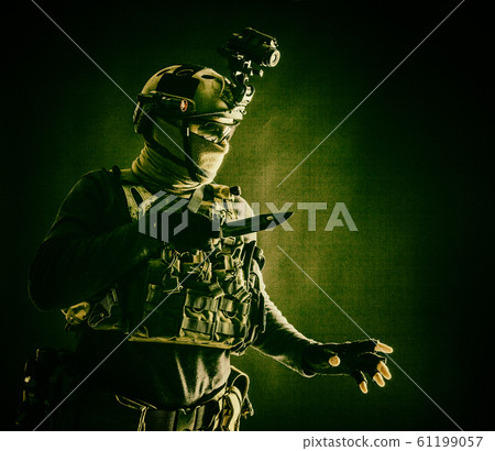 Commando fighter creeping in darkness with knife 61199057