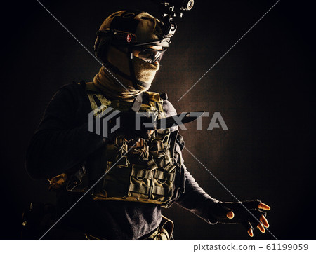 Commando fighter creeping in darkness with knife 61199059