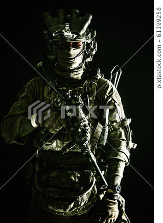 Army elite troops serviceman standing in darkness Army elite troops serviceman standing in darkness 61199258