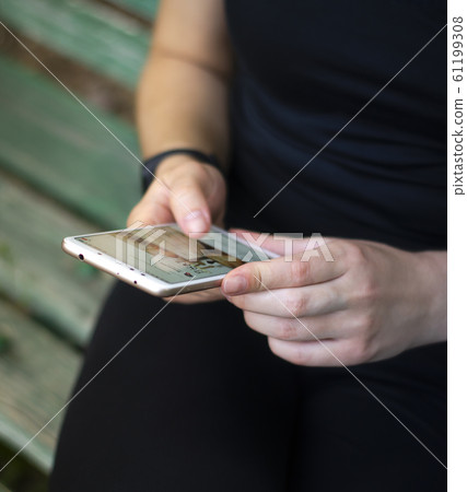 Girl leafing through a social network. Photo. 61199308