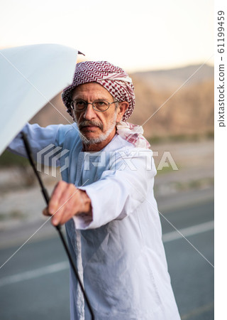 Arab man fixing his car outdoors 61199459