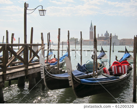 Traditional italian gondolas parking near berth. 61200320
