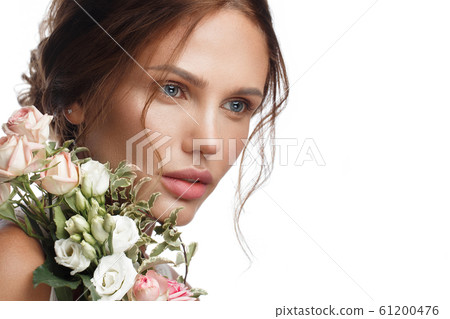 Beautiful woman with classic nude make-up, light hairstyle and flowers. Beauty face. 61200476