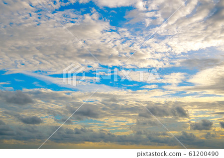 Cumulus and cirrus clouds on a blue sky. 61200490