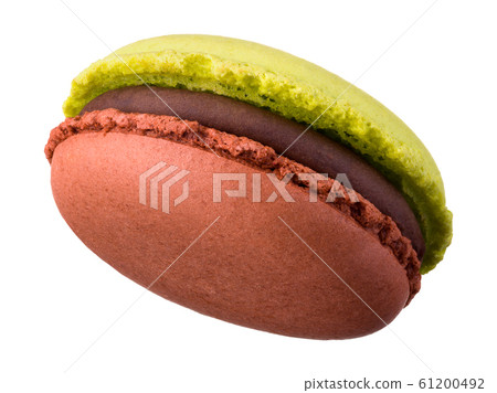 Macro photo of french caramel and pistachio macaroon isolated on white 61200492