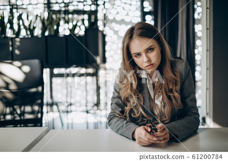 Thoughtful Young Business Woman Looking at Camera Thoughtful Young Business Woman Looking at Camera 61200784