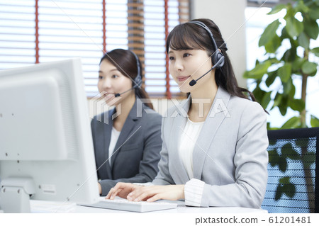 A young woman working at a call center: two operators A young woman working at a call center: two operators 61201481