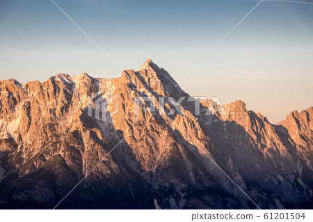 Mountain portrait Birnhorn Saalbach sunset purple light clouds snowy mountain Mountain portrait Birnhorn Saalbach sunset purple light clouds snowy mountain 61201504