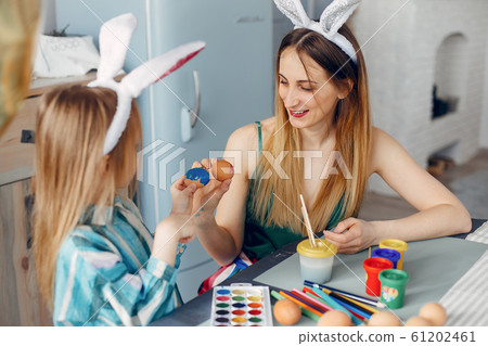Mother with little daughter in a kitchen 61202461
