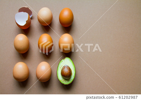 One half of row avocado, few chicken eggs and 61202987