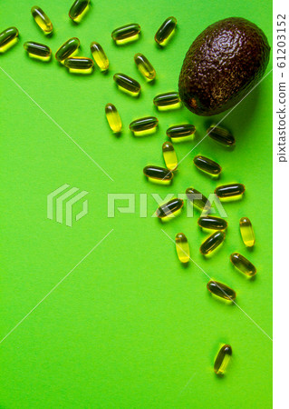 Row avocado on green backgroundand lots of 61203152
