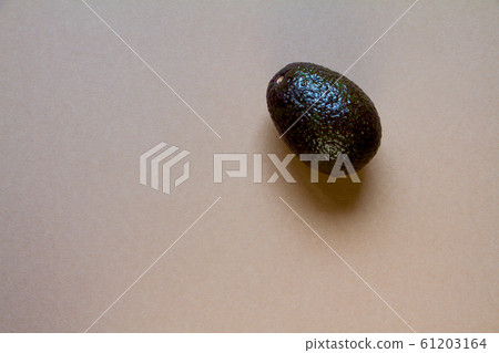 Row avocado on brown background, creative food 61203164