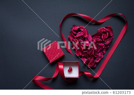Red petals and silk ribbon shaped in the shape of Red petals and silk ribbon shaped in the shape of 61203173