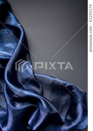 Dark blue fabric folds tulle or organza on a gray 61203174