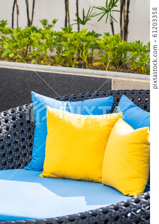 Outdoor patio in the garden with sofa chair and pillow decoration Outdoor patio in the garden with sofa chair and pillow decoration 61203358