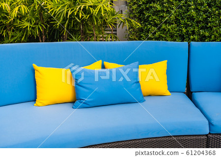Outdoor patio in the garden with sofa chair and pillow decoration Outdoor patio in the garden with sofa chair and pillow decoration 61204368