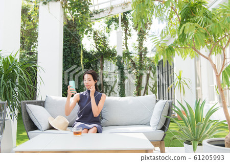 A woman operating a smartphone 61205993