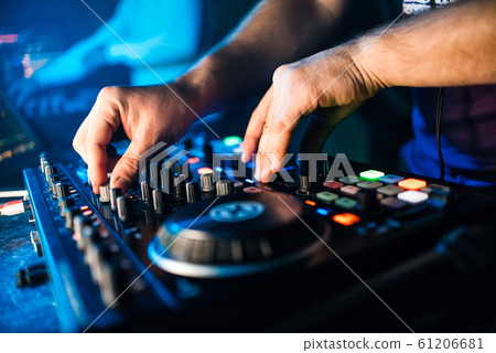 hands DJ music mixer is managing the volume 61206681