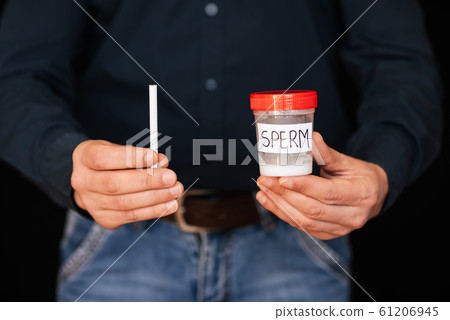 can of semen and a cigarette in the hands of a male smoker can of semen and a cigarette in the hands of a male smoker 61206945