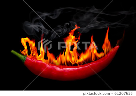 Red Hot chili pepper on fire and smoke at black background Red Hot chili pepper on fire and smoke at black background 61207635