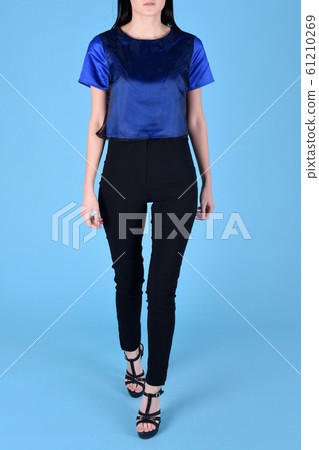 Woman brunette hair wearing blue color fashion clothes, business style for office. Model wear stylish trend clothing classic blue 2020 cotton casual style. Studio shot on light blue background 61210269